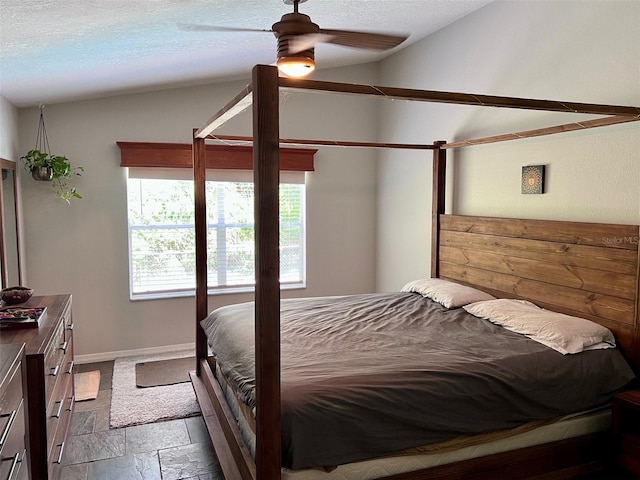 1430 Arrowhead Trl, Deltona, FL 32725 - bedroom with vaulted ceiling, multiple windows, stone tile floors, baseboards, and a textured ceiling