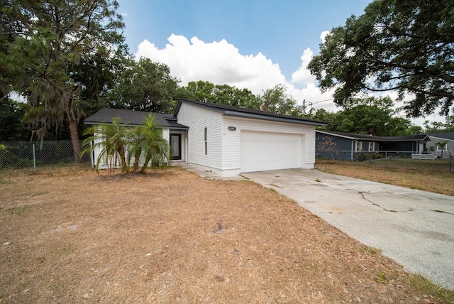 view of front facade featuring concrete driveway and an attached garage