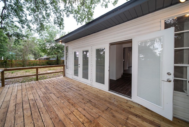 wooden deck featuring fence and french doors