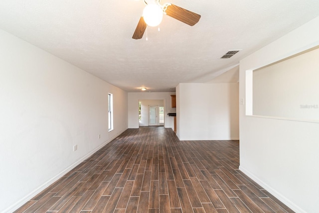 unfurnished room with baseboards, dark wood finished floors, and ceiling fan