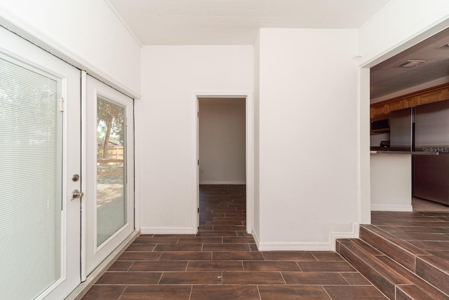 entryway with wood finish floors and baseboards