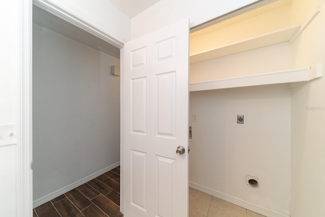 washroom featuring electric dryer hookup, baseboards, and wood finished floors