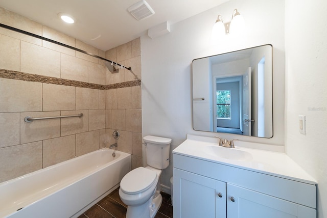 full bath featuring toilet, vanity, and bathtub / shower combination