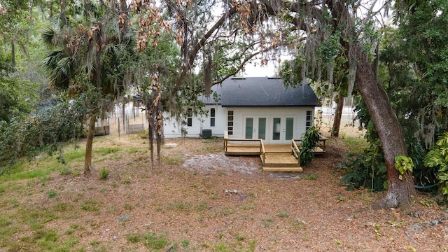 rear view of house with french doors, a deck, roof with shingles, and cooling unit