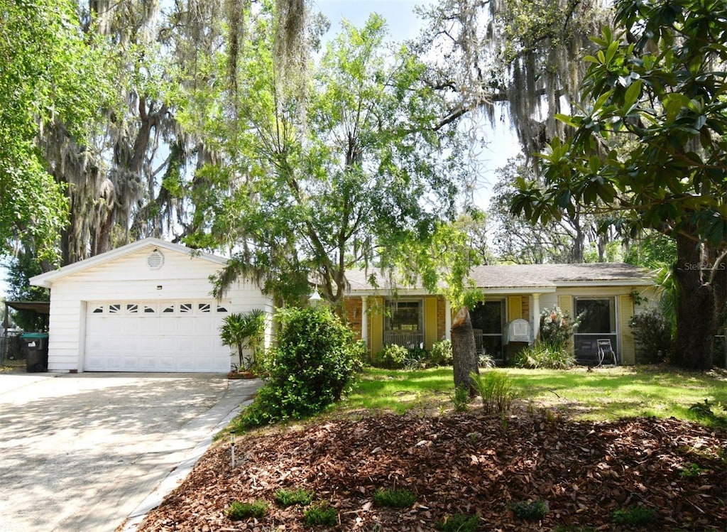 6105 Lost Tree Ct, Orlando, FL 32808 - ranch-style home featuring a garage, concrete driveway, and a front lawn