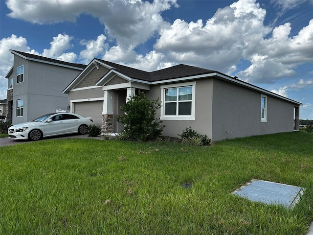 1141 Lakeshore Breeze Pl, Kissimmee, FL 34747 - view of front of house with stucco siding, a garage, a front yard, and stone siding