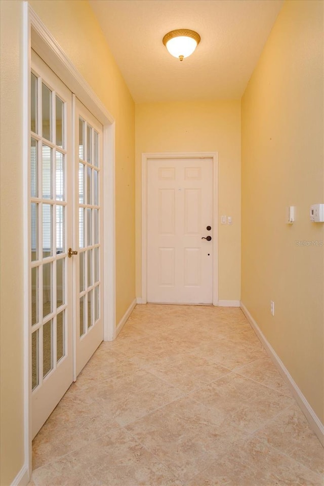entryway featuring french doors and baseboards
