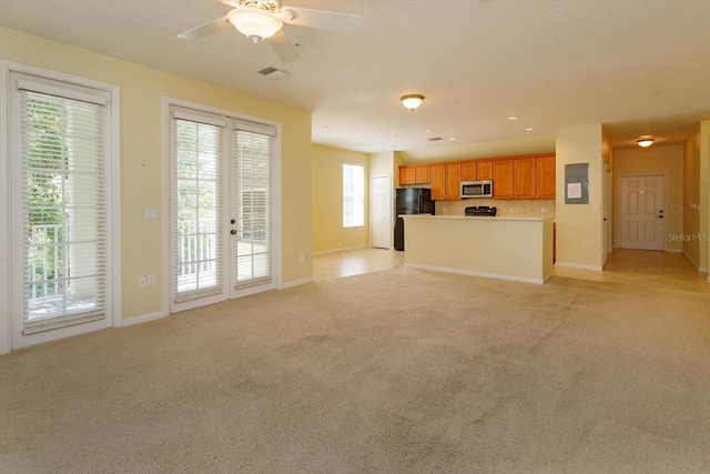 unfurnished living room with light carpet, baseboards, ceiling fan, and french doors