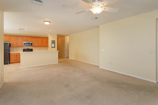 unfurnished living room with baseboards and light carpet