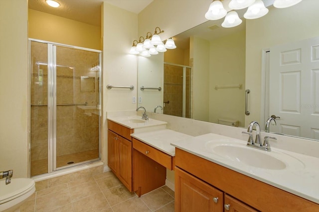 bathroom with toilet, a shower stall, double vanity, and tile patterned flooring
