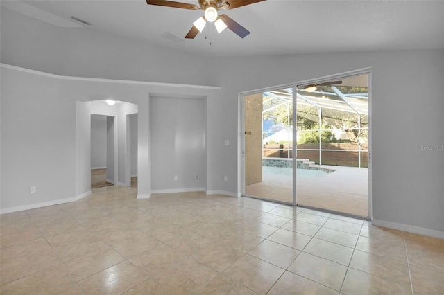 2643 Alamosa Pl, Lake Mary, FL 32746 - spare room with a ceiling fan, a sunroom, lofted ceiling, light tile patterned floors, and baseboards