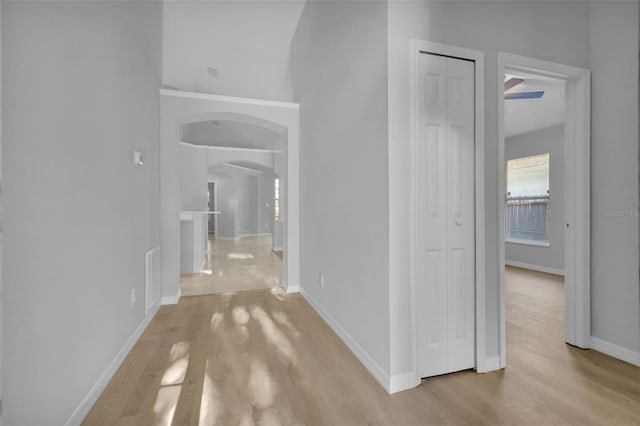 2643 Alamosa Pl, Lake Mary, FL 32746 - hall featuring arched walkways, light wood-style flooring, and baseboards