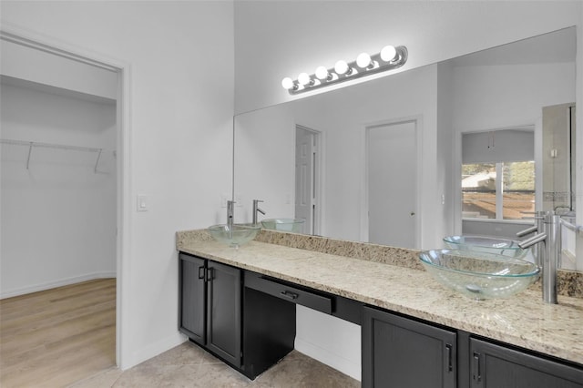 2643 Alamosa Pl, Lake Mary, FL 32746 - full bath with double vanity, a walk in closet, and baseboards