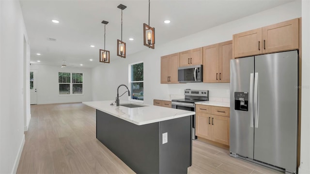 1371 Lake Dr, Casselberry, FL 32707 - kitchen with appliances with stainless steel finishes, a sink, light wood-style floors, light brown cabinets, and recessed lighting
