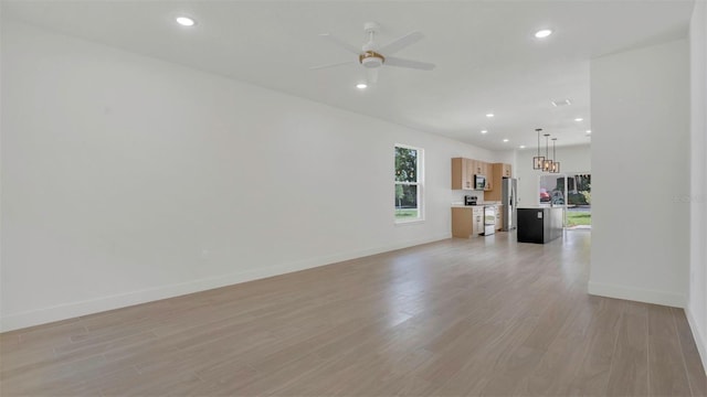 1371 Lake Dr, Casselberry, FL 32707 - unfurnished living room featuring a ceiling fan, recessed lighting, light wood-style floors, and baseboards