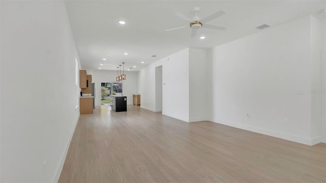 1371 Lake Dr, Casselberry, FL 32707 - unfurnished living room featuring recessed lighting, ceiling fan, baseboards, and light wood finished floors