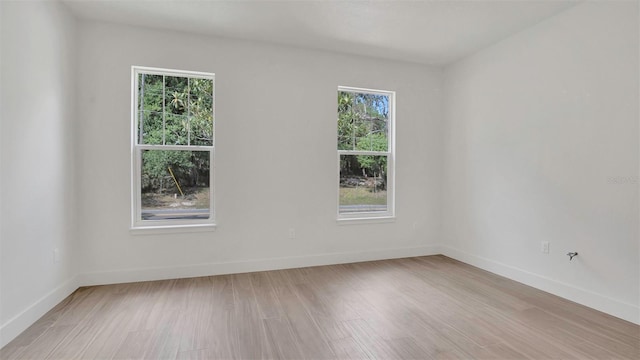 1371 Lake Dr, Casselberry, FL 32707 - empty room with plenty of natural light, light wood finished floors, and baseboards