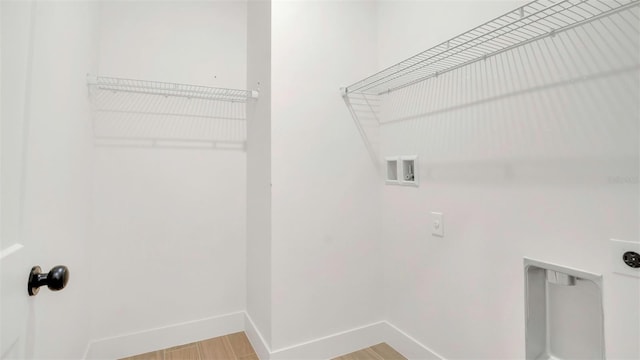 1371 Lake Dr, Casselberry, FL 32707 - laundry room with electric dryer hookup, hookup for a washing machine, baseboards, and wood finished floors