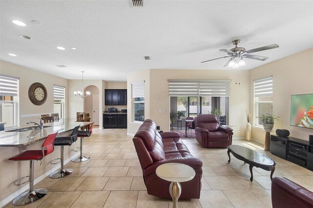 2136 J Lawson Blvd, Orlando, FL 32824 - living room with healthy amount of natural light, recessed lighting, baseboards, a chandelier, and a textured ceiling