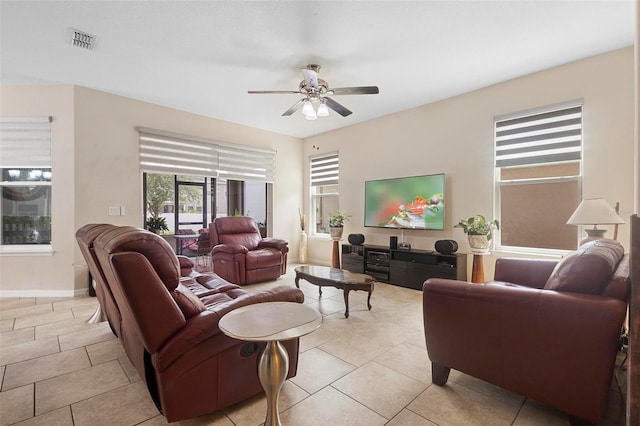 2136 J Lawson Blvd, Orlando, FL 32824 - living room featuring plenty of natural light, ceiling fan, light tile patterned floors, and baseboards