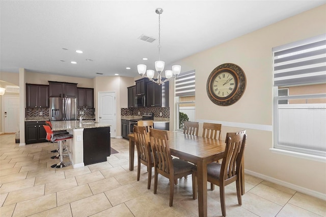 2136 J Lawson Blvd, Orlando, FL 32824 - dining room featuring a chandelier, recessed lighting, light tile patterned flooring, and baseboards
