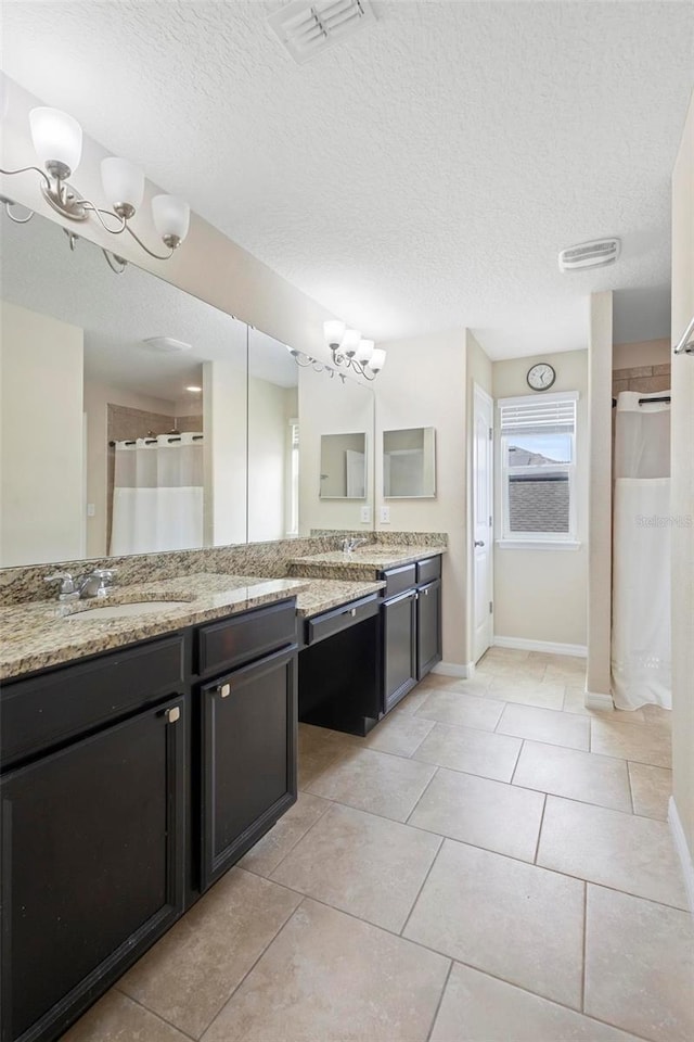 2136 J Lawson Blvd, Orlando, FL 32824 - bathroom with a chandelier, a textured ceiling, baseboards, vanity, and tile patterned floors