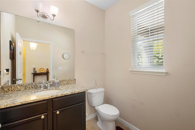 2136 J Lawson Blvd, Orlando, FL 32824 - bathroom featuring toilet, baseboards, and vanity