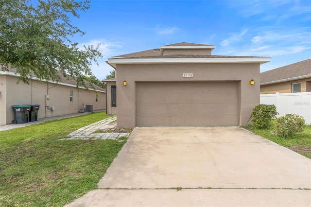 2136 J Lawson Blvd, Orlando, FL 32824 - view of front of property featuring central AC unit, an attached garage, concrete driveway, and stucco siding