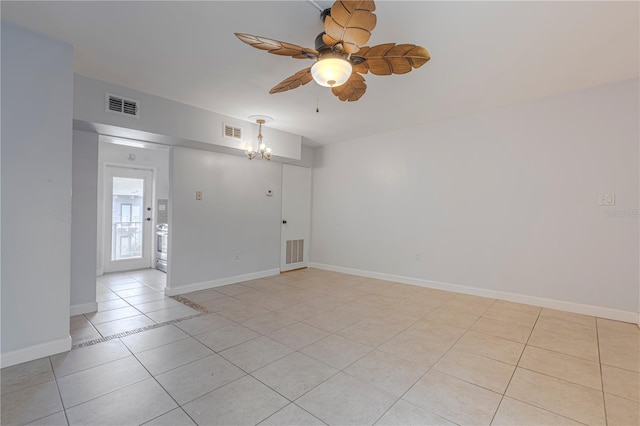 empty room with ceiling fan, a chandelier, light tile patterned floors, and baseboards
