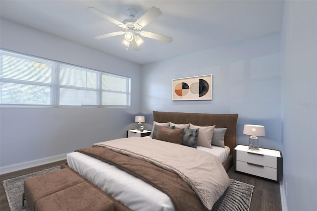 bedroom featuring dark wood finished floors, baseboards, and a ceiling fan