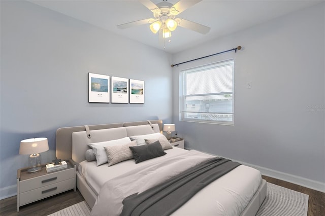 bedroom with wood finished floors, baseboards, and a ceiling fan