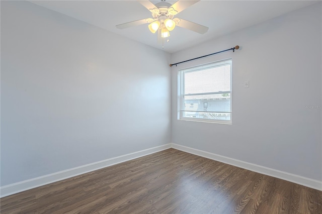 empty room with dark wood-style flooring, baseboards, and a ceiling fan