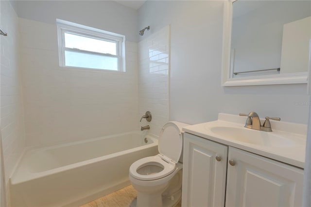bathroom featuring shower / washtub combination, toilet, vanity, and wood finished floors
