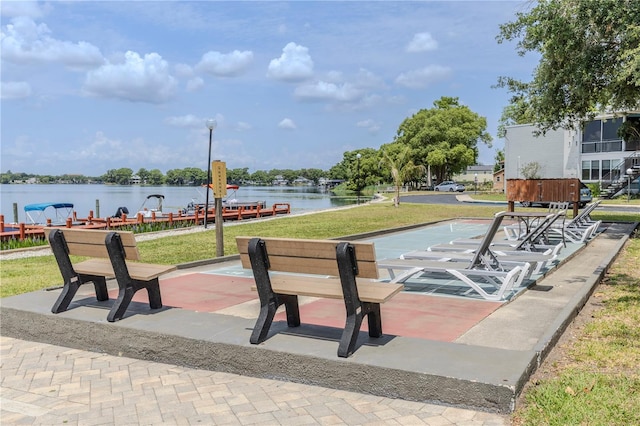 view of home's community featuring a water view and a yard