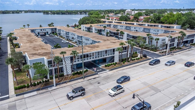 drone / aerial view of a nearby body of water and apartment complex