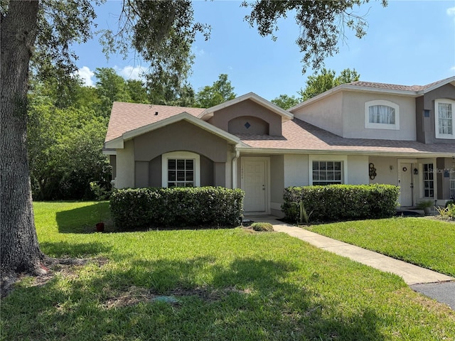 14844 Laguna Beach Cir, Orlando, FL 32824 - view of front facade with stucco siding and a front lawn