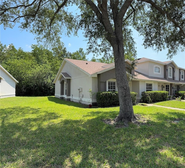 14844 Laguna Beach Cir, Orlando, FL 32824 - view of property exterior with a lawn and stucco siding