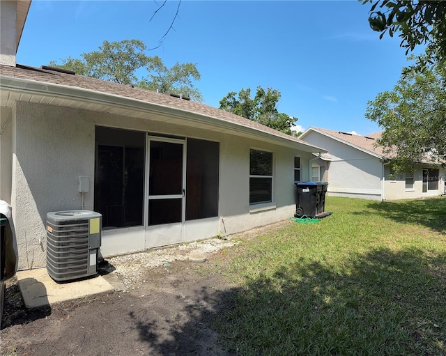 14844 Laguna Beach Cir, Orlando, FL 32824 - back of property featuring stucco siding, central AC, a yard, and roof with shingles