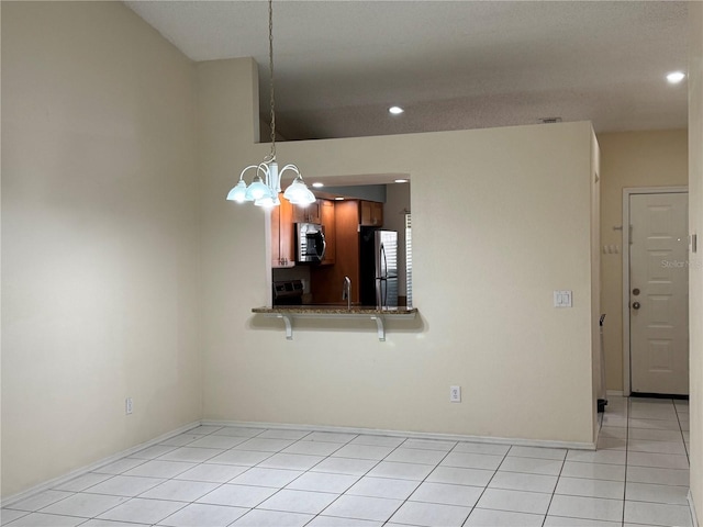 14844 Laguna Beach Cir, Orlando, FL 32824 - unfurnished dining area featuring a chandelier, recessed lighting, light tile patterned floors, and baseboards