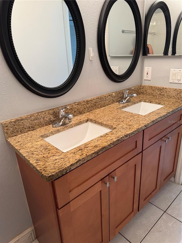 14844 Laguna Beach Cir, Orlando, FL 32824 - bathroom with double vanity, tile patterned floors, and a textured wall