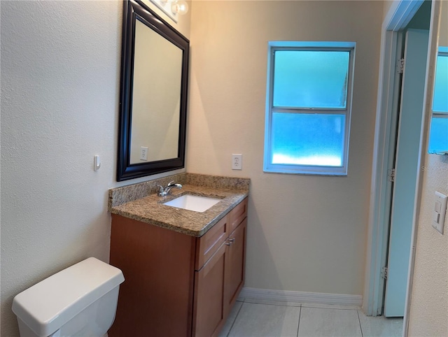 14844 Laguna Beach Cir, Orlando, FL 32824 - half bathroom featuring vanity, tile patterned floors, baseboards, and toilet