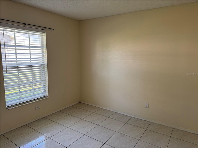 14844 Laguna Beach Cir, Orlando, FL 32824 - spare room with light tile patterned floors, baseboards, and a textured ceiling