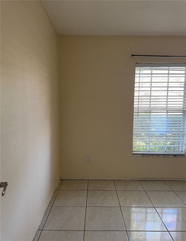 14844 Laguna Beach Cir, Orlando, FL 32824 - empty room featuring healthy amount of natural light and light tile patterned flooring