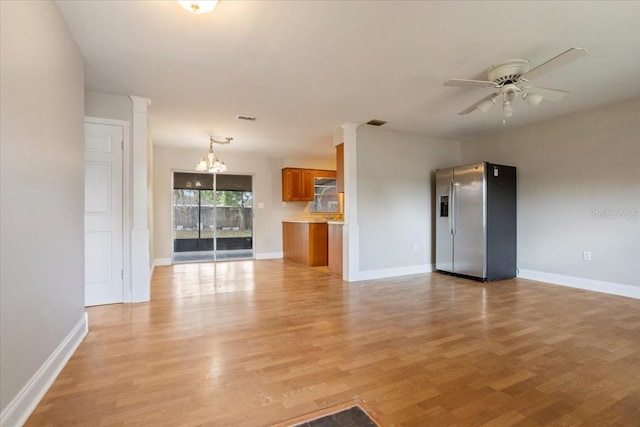 408 Eunice Dr, Plant City, FL 33563 - unfurnished living room with ornate columns, ceiling fan, light wood finished floors, and baseboards