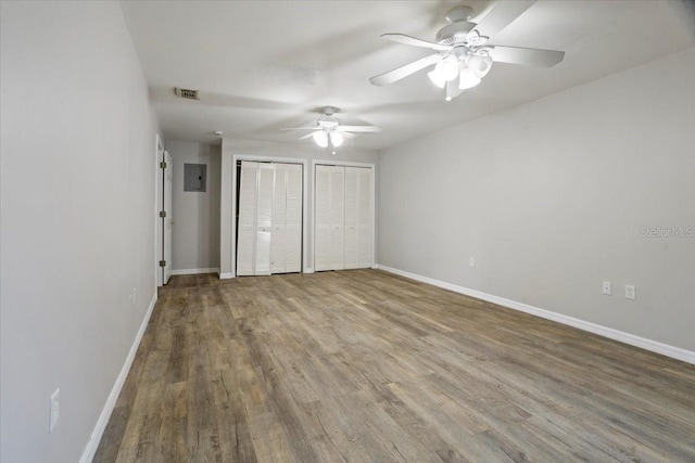 408 Eunice Dr, Plant City, FL 33563 - unfurnished bedroom with multiple closets, wood finished floors, baseboards, and a ceiling fan