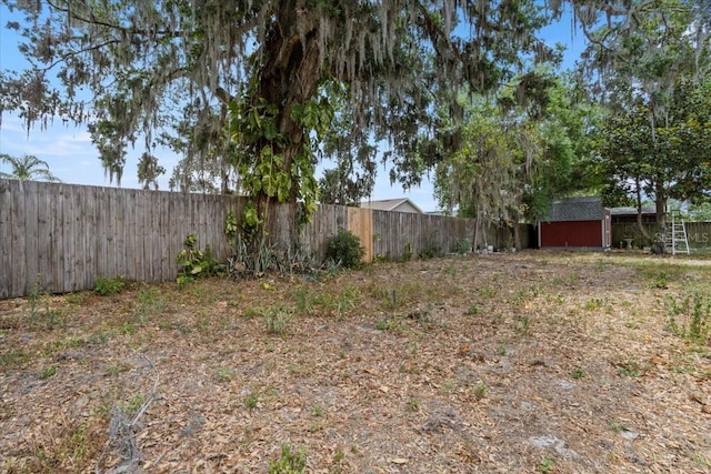 408 Eunice Dr, Plant City, FL 33563 - fenced backyard featuring a shed and an outbuilding