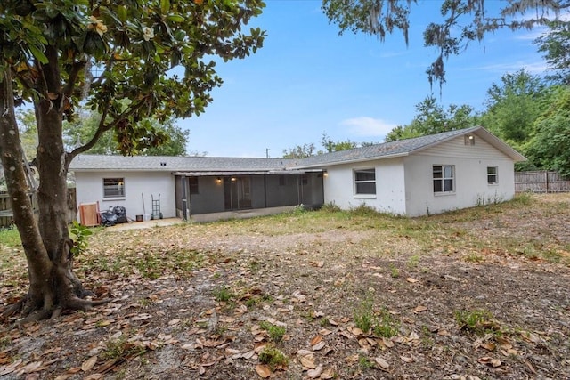 408 Eunice Dr, Plant City, FL 33563 - rear view of property featuring a sunroom, stucco siding, and fence