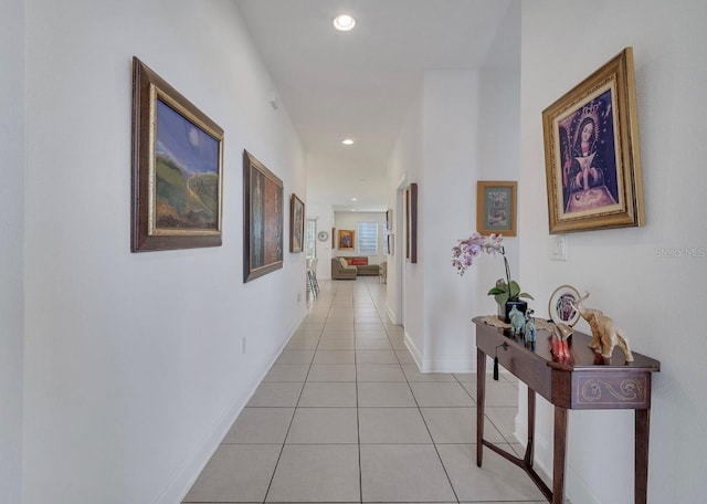 corridor with light tile patterned floors, recessed lighting, and baseboards