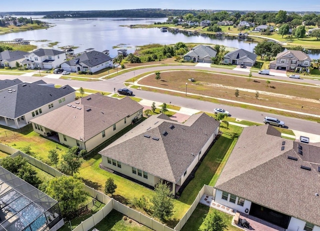 aerial view of residential area featuring a large body of water