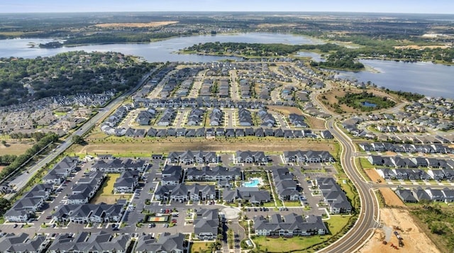 aerial view of property's location with a nearby body of water and nearby suburban area